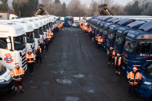 Large fleet of Ballards Removals vehicles with employees at Christmas