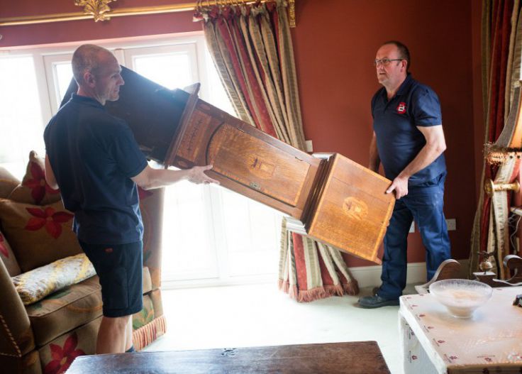 Ballards Removals team members moving furniture