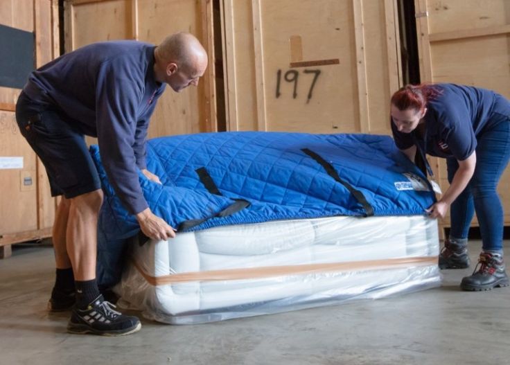 Ballards employees moving furniture into storage