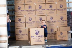 Children with Ballards Removals cardboard boxes