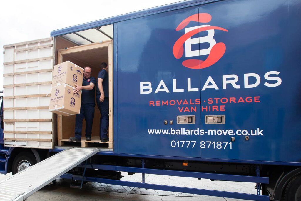 Ballards Removals carrying boxes out of a van during house clearance