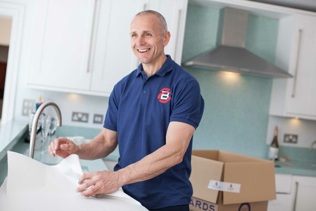 Ballards Removals staff packaging breakable items during a move