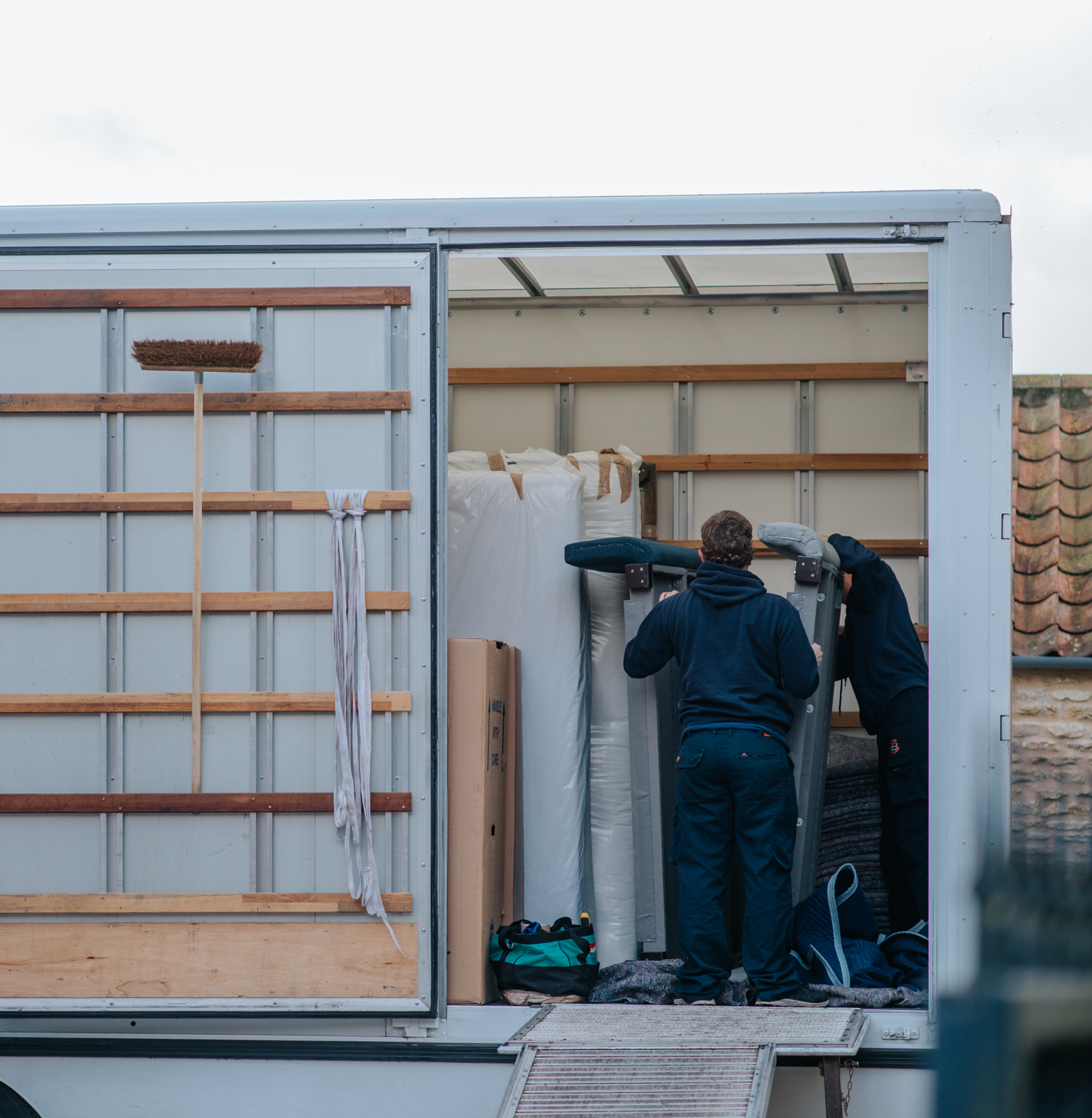 Ballards removals team members carefully loading the lorry with a bed frame