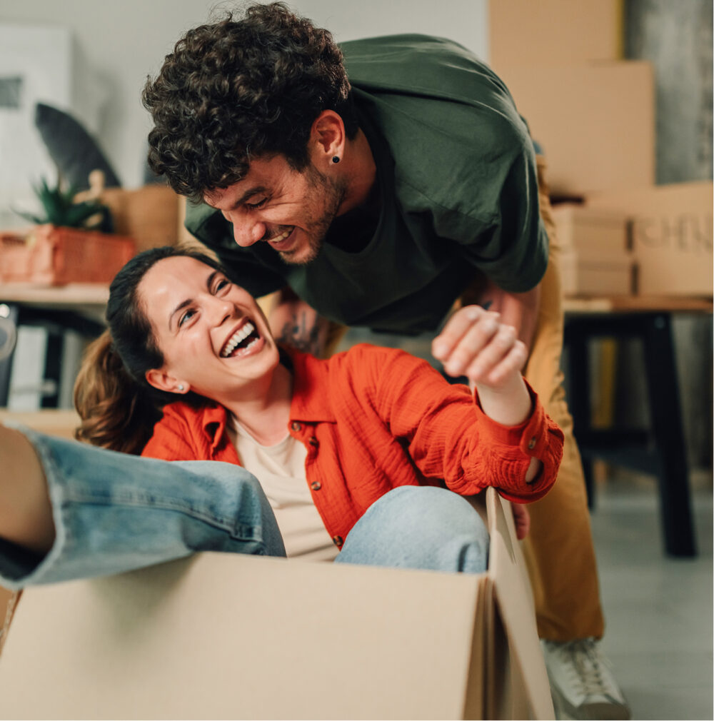 Man pushing woman in removals box