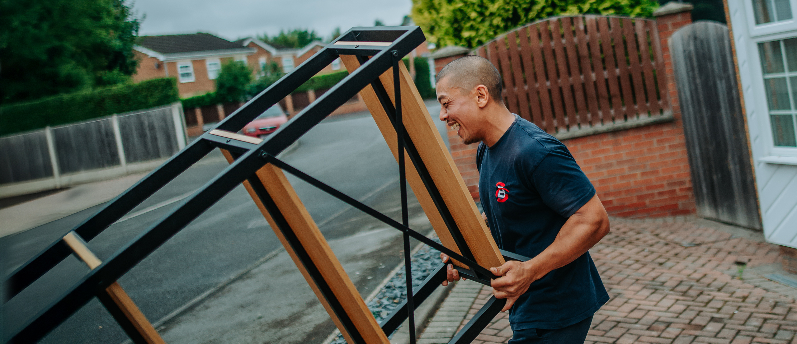 Ballards member loading the lorry with a freestanding shelf unit