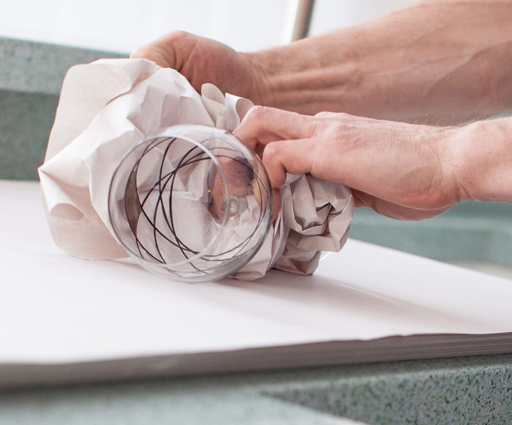 Ballards removals team carefully wrapping a glass
