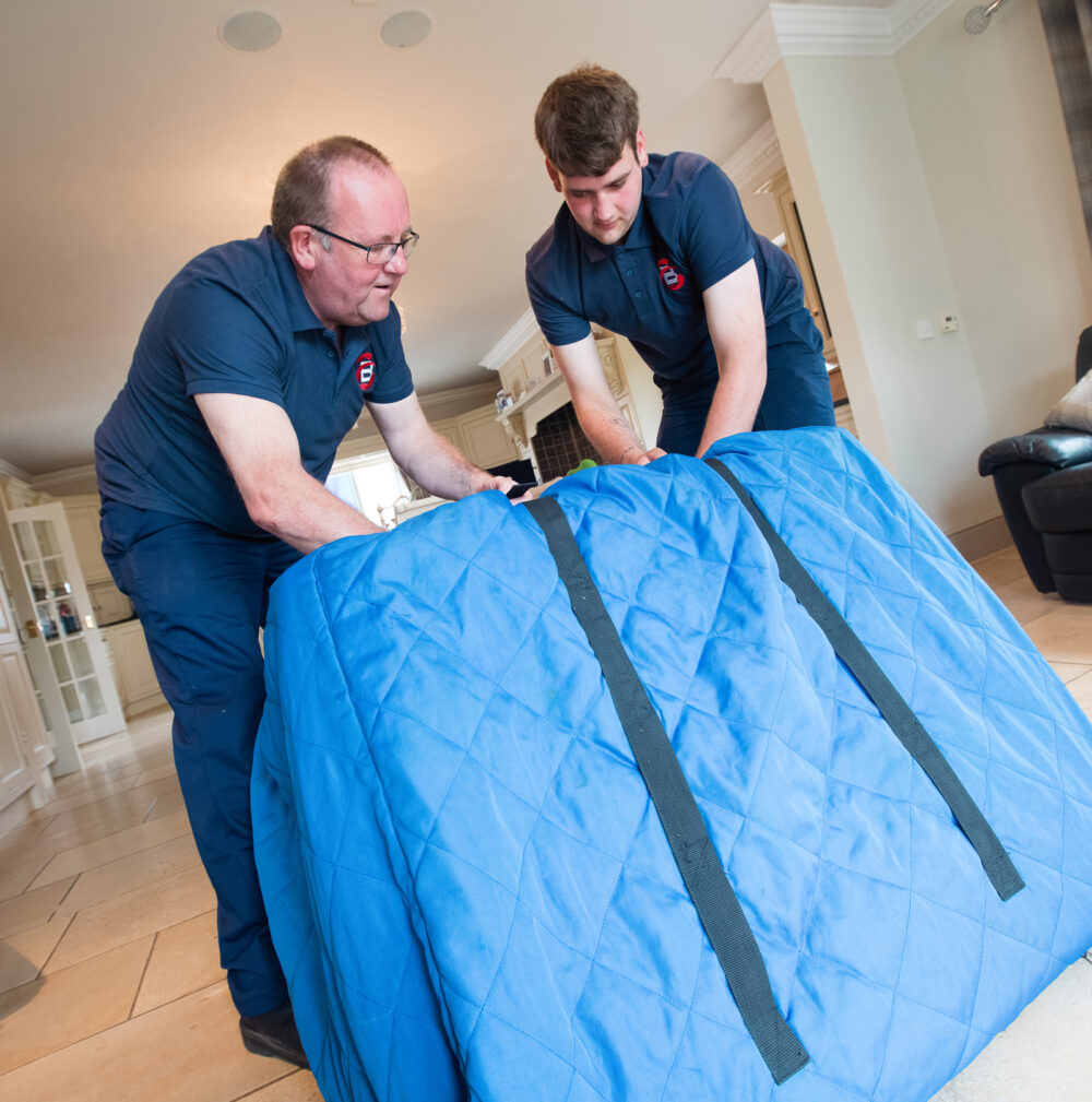Ballards team members putting items in protective packaging ready for removal