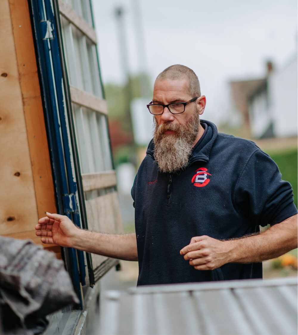 Ballards staff member stood next to removals truck