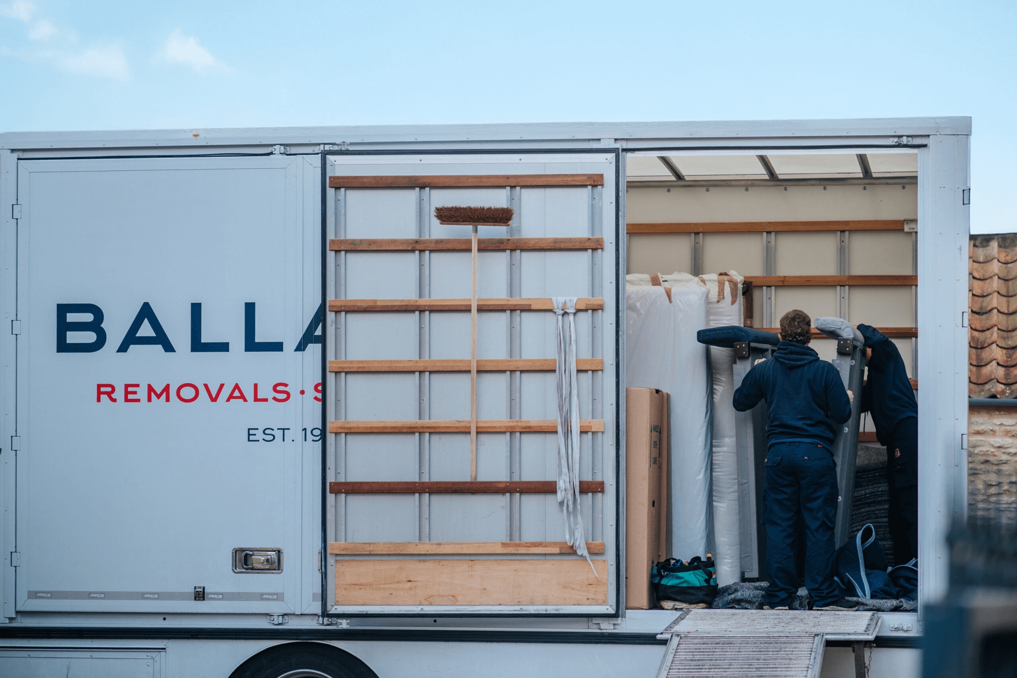 Ballards removals team member carefully unloading the removals lorry.