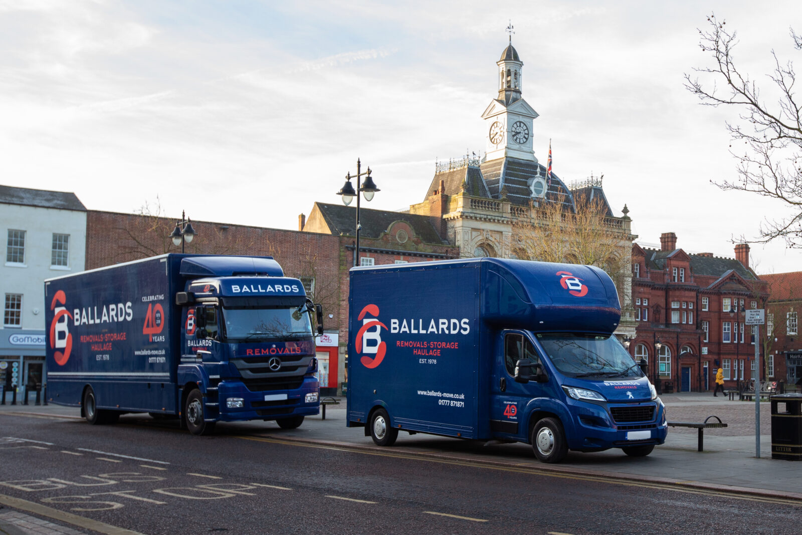 Two Ballards Removals Vans pictured in MArket Square, Retford with the town Hall visible in the background
