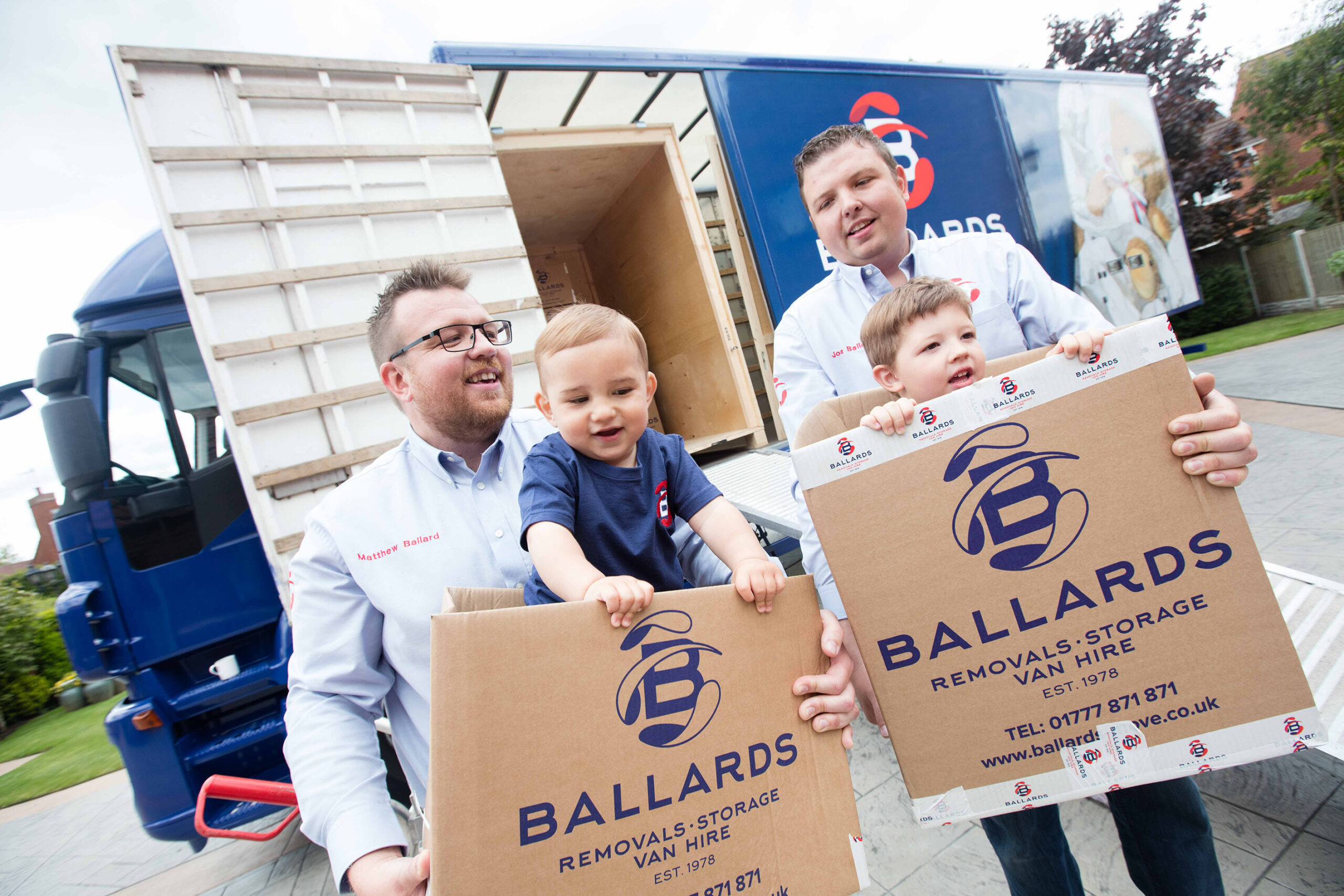 Matthew and Joe Ballard carrying their children in Ballards removal boxes