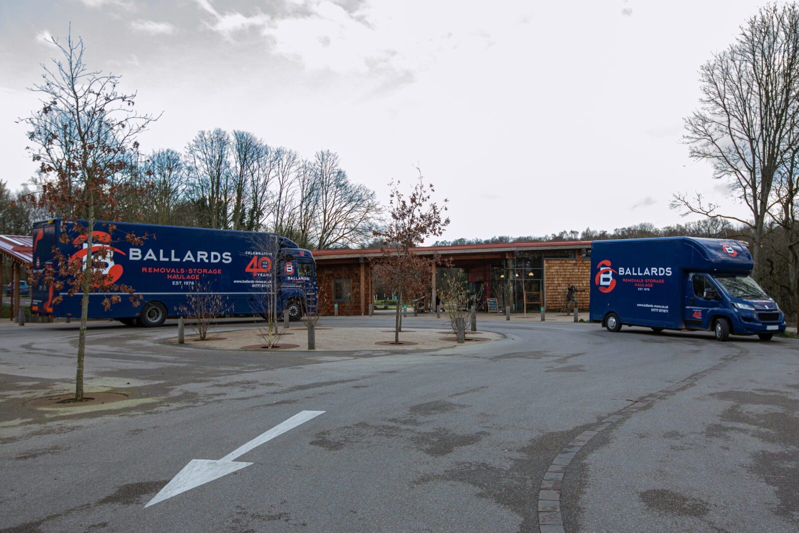 Ballards Removals trucks parked outside a modern service station building in Nottingham.