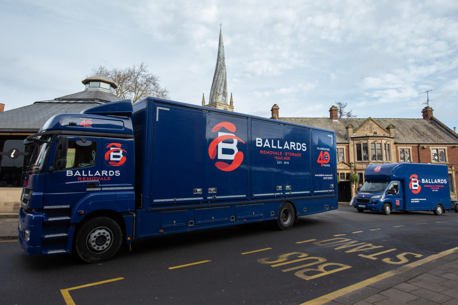 Ballards Removals trucks parked in Chesterfield town centre near the Church of St Mary and All Saints and its famous crooked spire.