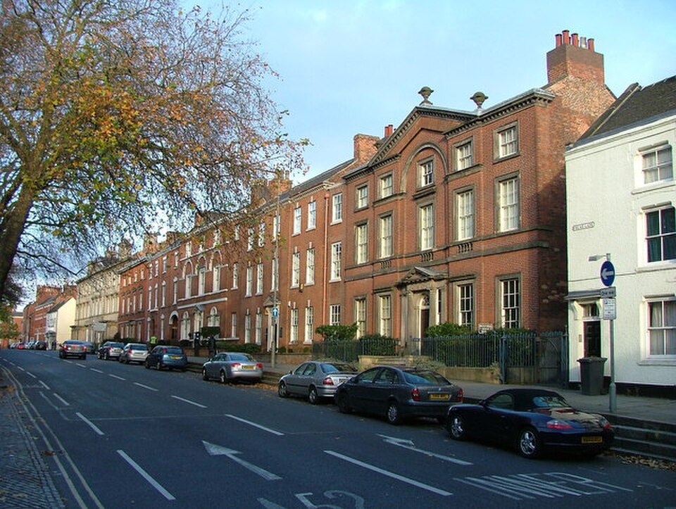 A row of Georgian town houses on Friar Gate in Derby. The buildings have brick facades, tall sash windows and decorative period details.