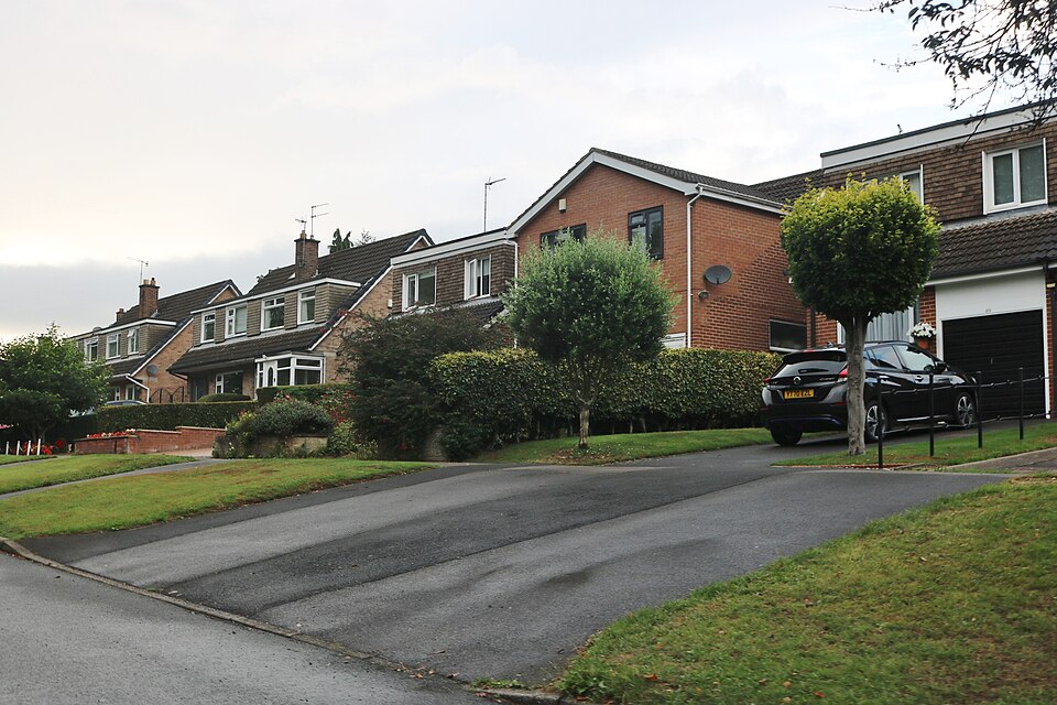 Houses along Cinderhill Lane in Sheffield, showing brick homes on a quiet residential street with greenery.