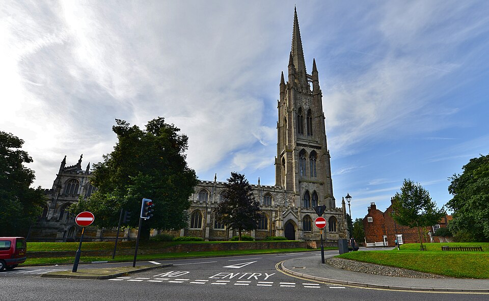 St James’s Church in Louth, showing its tall spire, surrounding streets and historic architecture on a clear day.