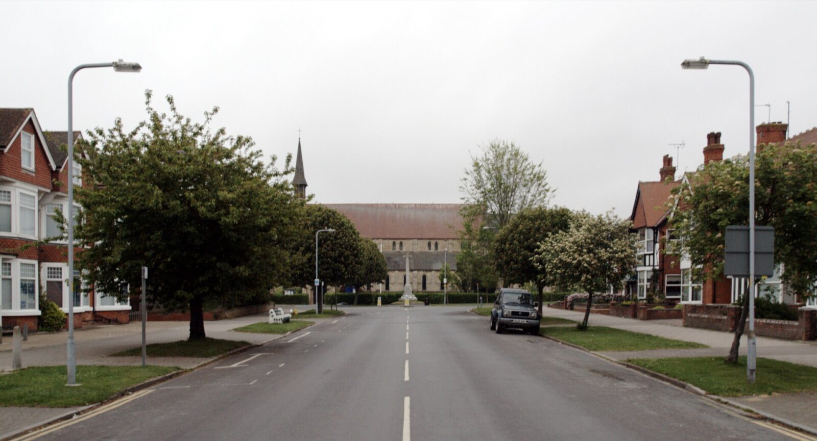 A view along Lumley Avenue in Skegness, showing a quiet street lined with houses and a church building, with clear skies overhead.