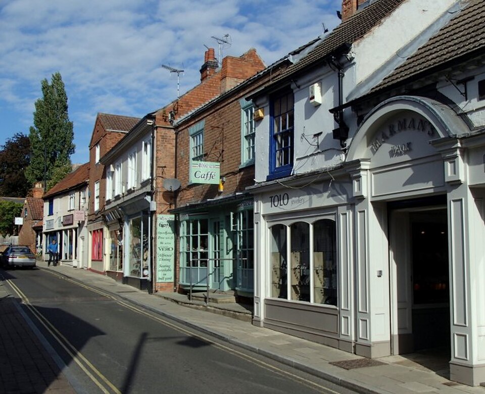 Shops along Queen Street in Southwell, showing a row of traditional buildings with storefronts on a quiet street.