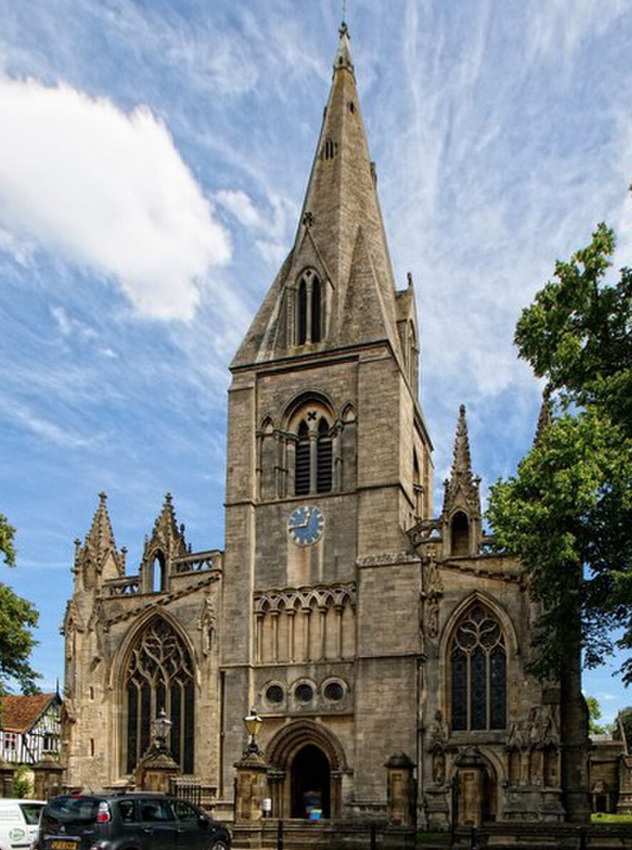 St Denys’ Church in Sleaford, Lincolnshire, with the church tower and surrounding churchyard visible on a clear day.